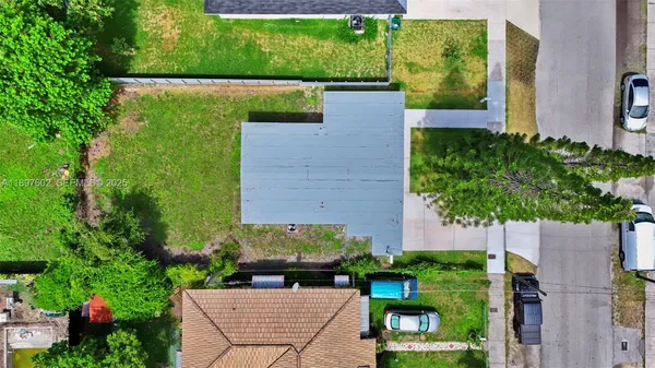 an aerial view of a house with a yard