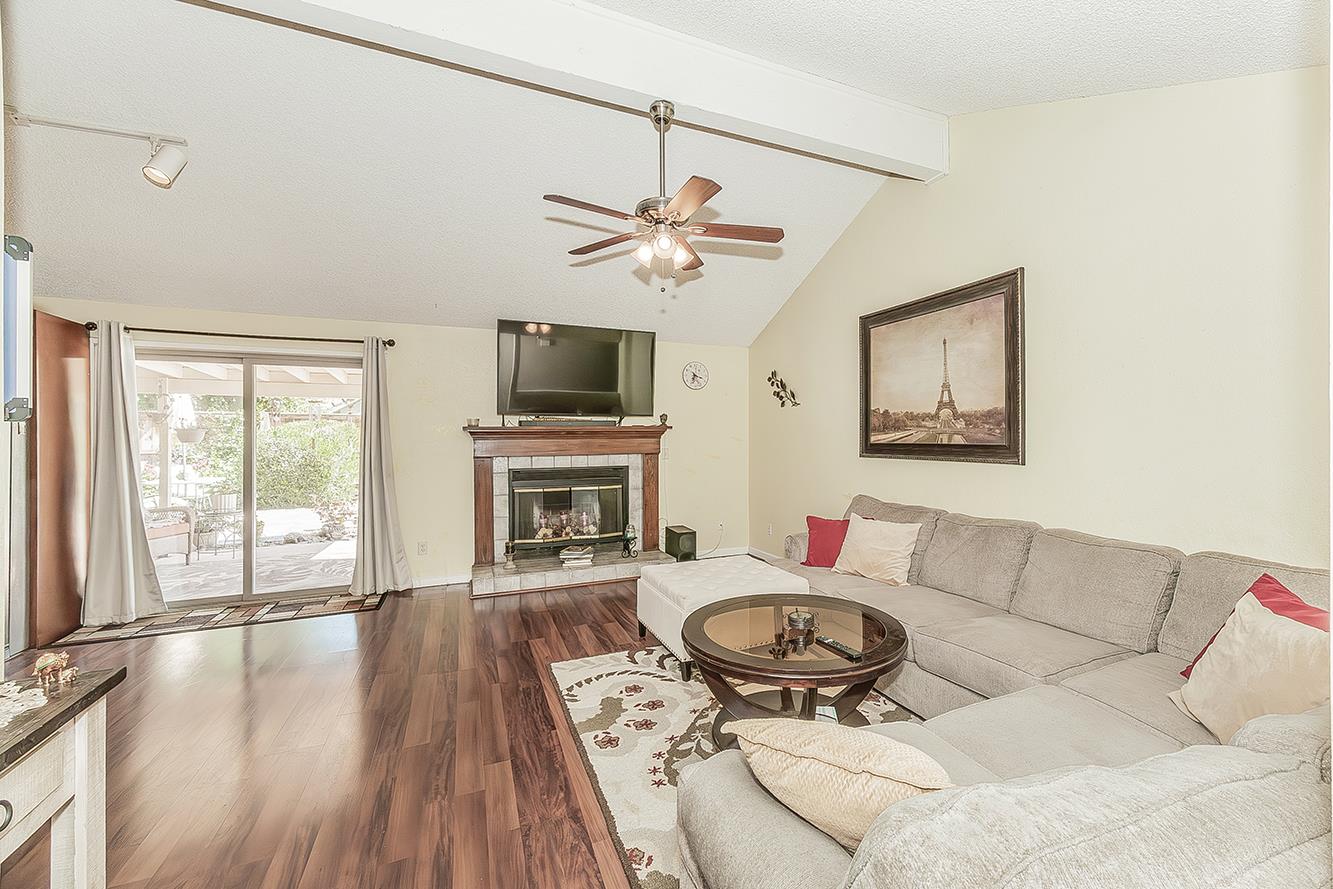 1908 East Niles Avenue Fresno, CA 93720 - Photo 12 of 30 a living room with furniture a fireplace and a flat screen tv