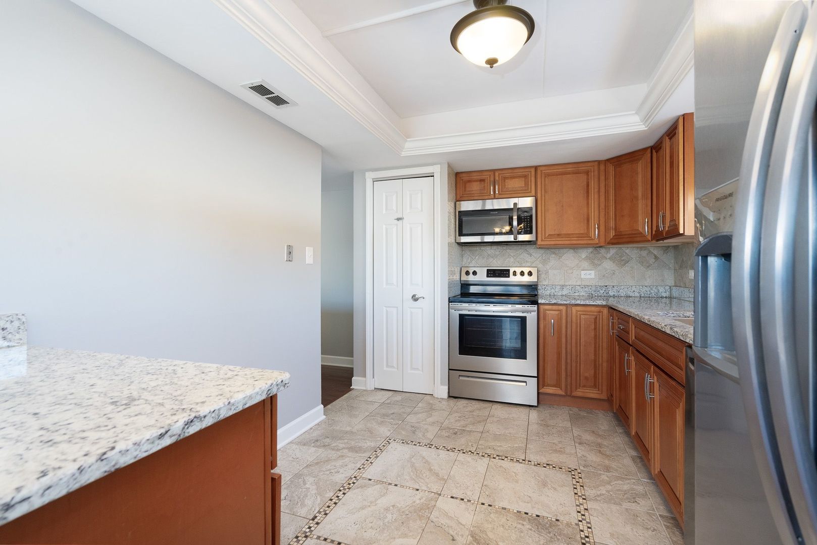 11137 E Road, Unit C Palos Hills, IL 60465 - Photo 12 of 29 a kitchen with granite countertop a stove top oven sink and cabinets