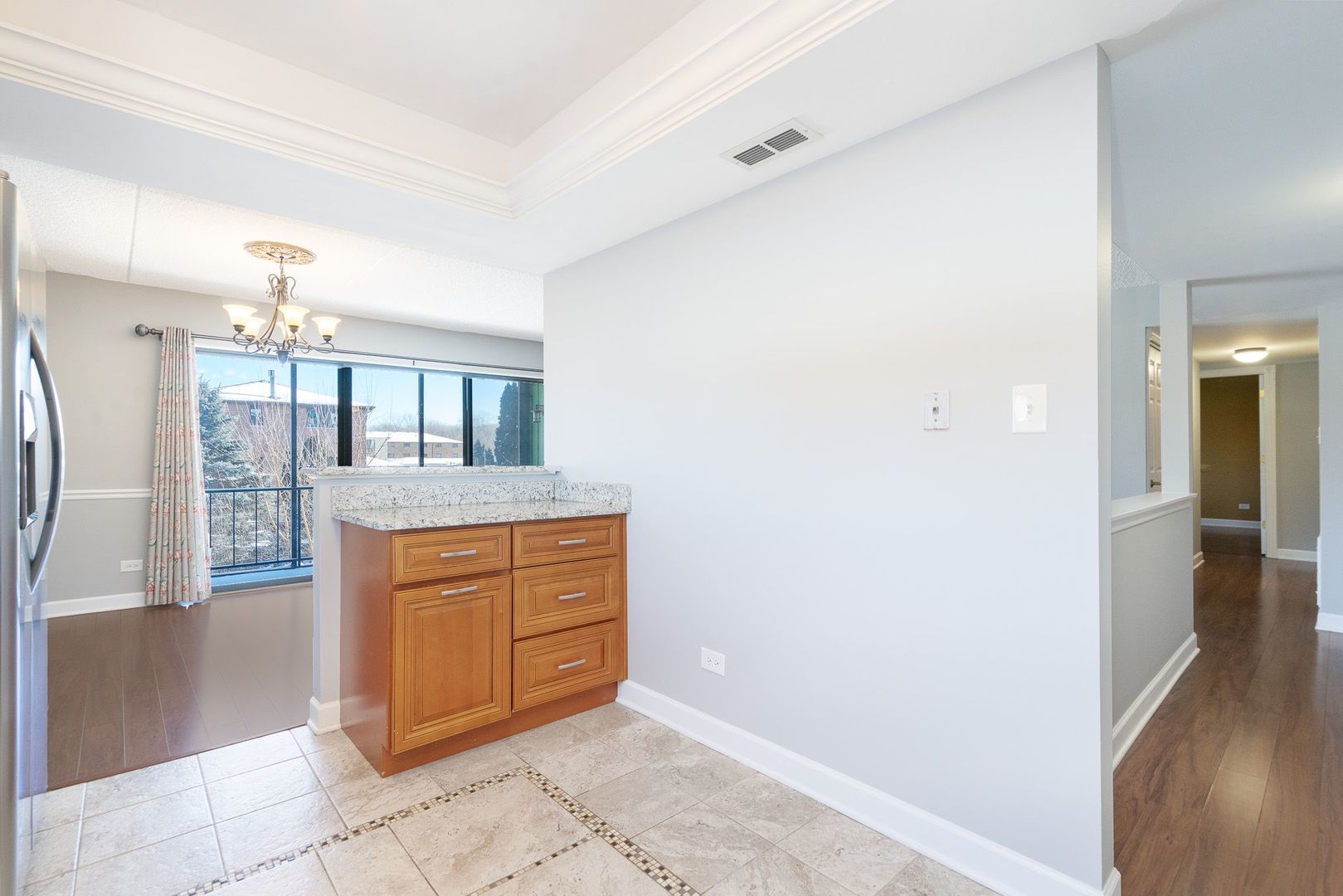 11137 E Road, Unit C Palos Hills, IL 60465 - Photo 13 of 29 a room with kitchen island cabinets and refrigerator
