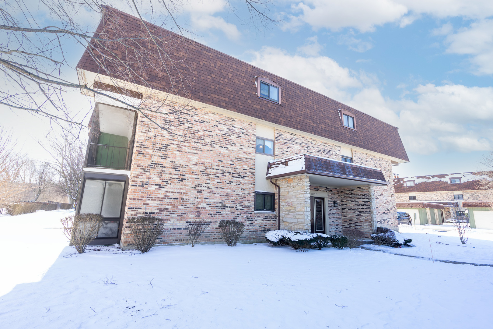 11137 E Road, Unit C Palos Hills, IL 60465 - Photo 2 of 29 a view of a brick building with many windows