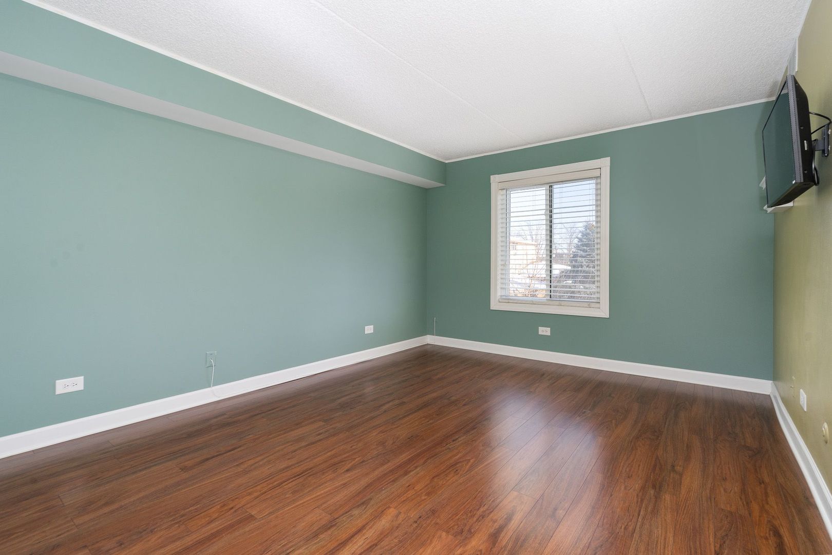 11137 E Road, Unit C Palos Hills, IL 60465 - Photo 21 of 29 an empty room with wooden floor and windows