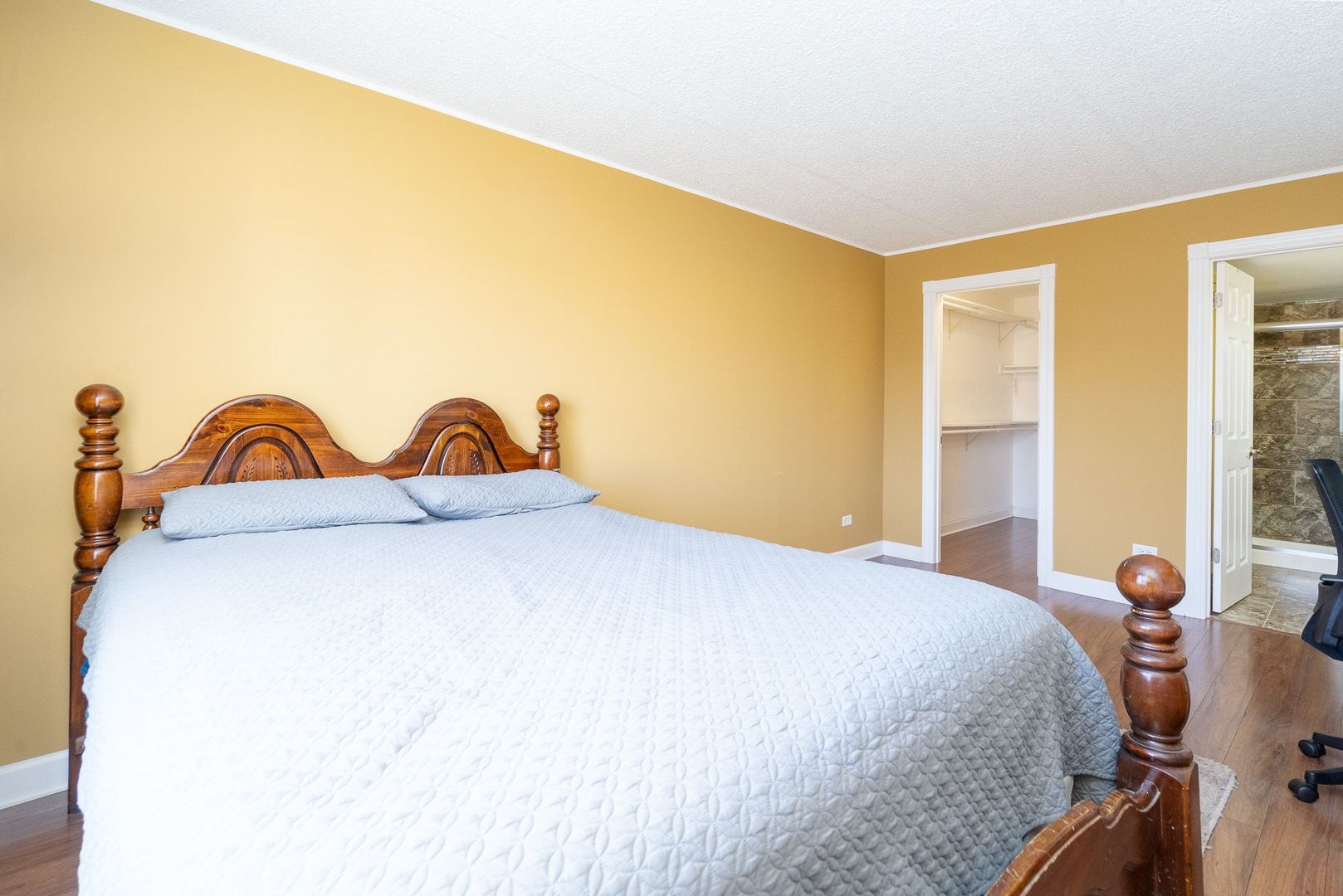 11137 E Road, Unit C Palos Hills, IL 60465 - Photo 24 of 29 a bedroom with a bed and a painting on the wall