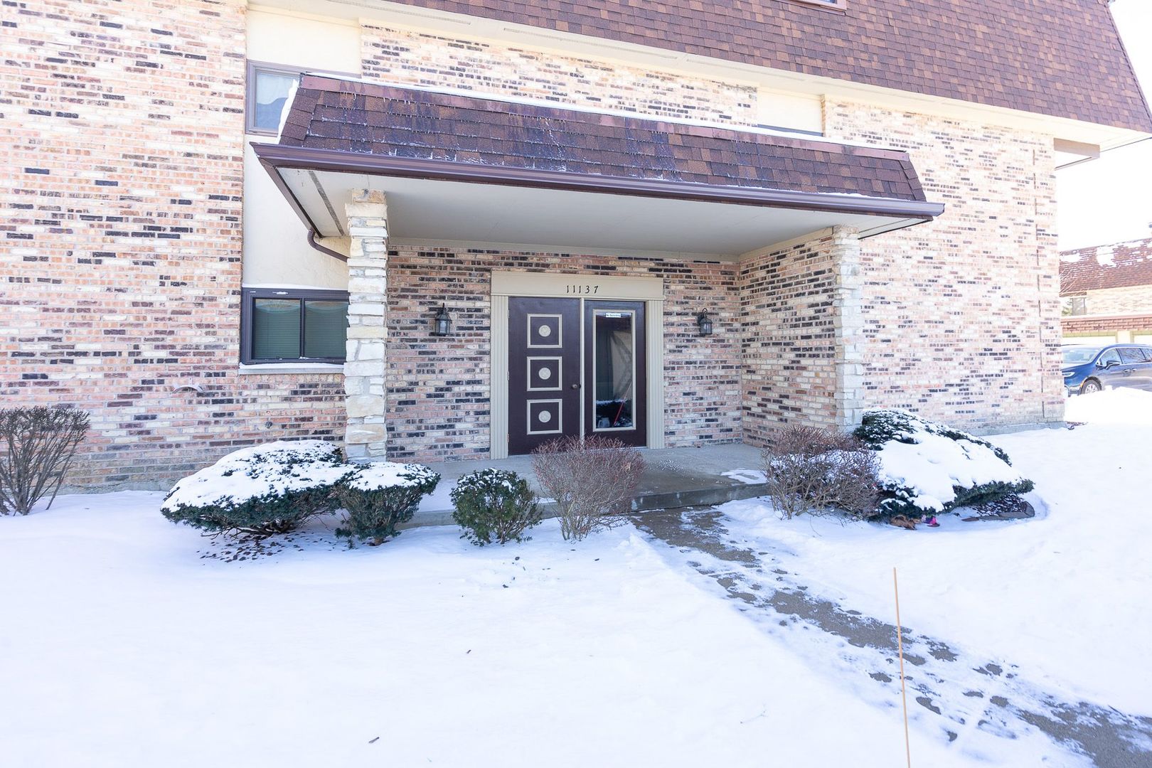 11137 E Road, Unit C Palos Hills, IL 60465 - Photo 3 of 29 a front view of a house with a garden