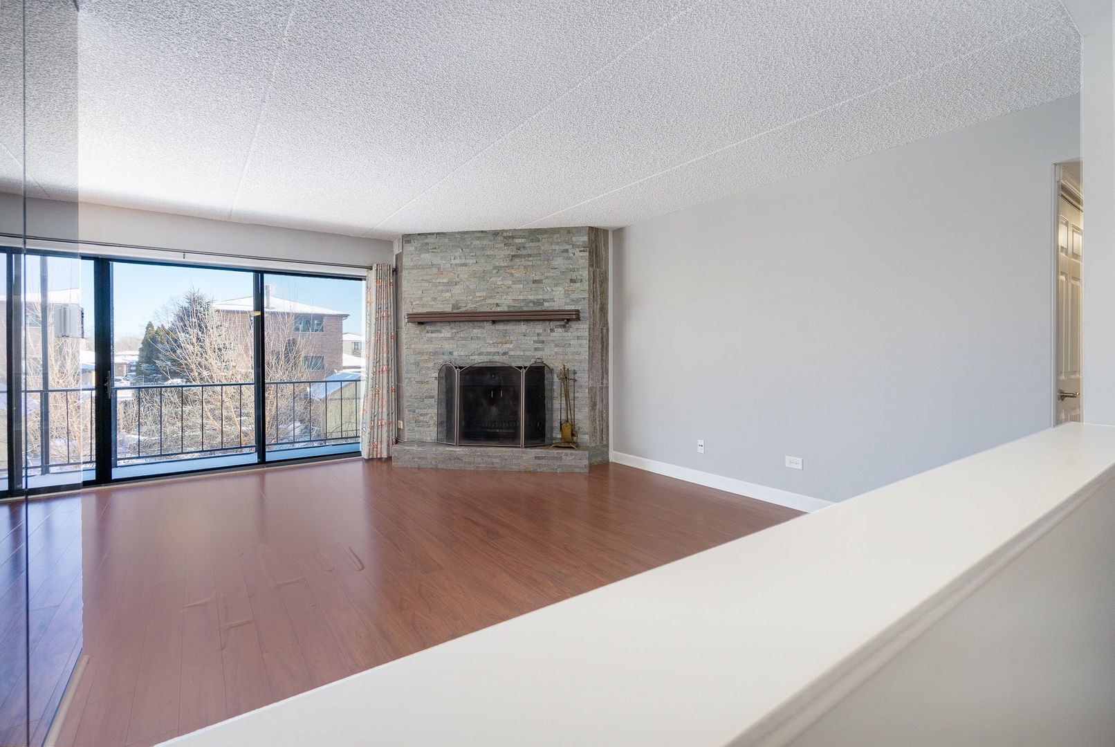 11137 E Road, Unit C Palos Hills, IL 60465 - Photo 8 of 29 a view of an empty room with wooden floor and a window
