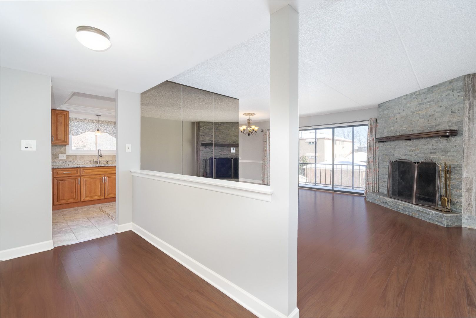 11137 E Road, Unit C Palos Hills, IL 60465 - Photo 9 of 29 an empty room with wooden floor and a fireplace