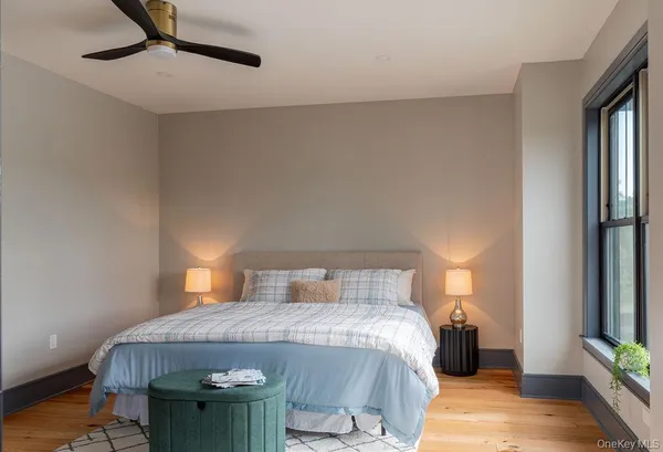 a bedroom with a bed and a potted plant