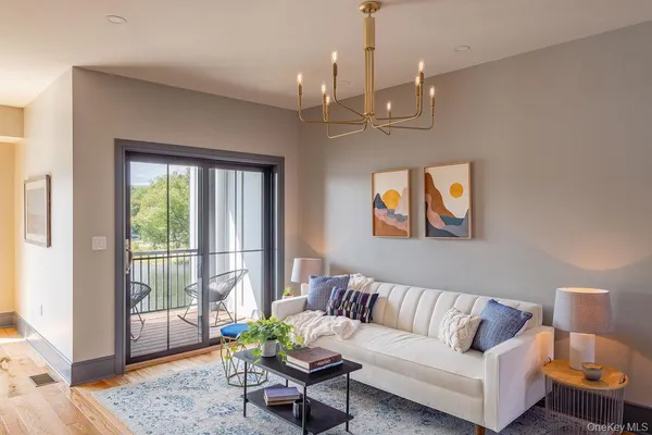 a living room with furniture and a chandelier