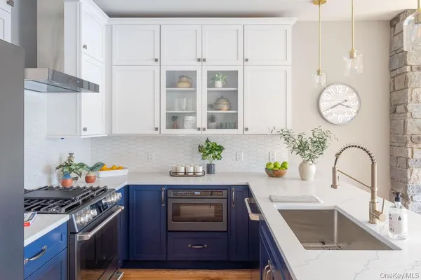 a kitchen with stainless steel appliances a stove a sink and a refrigerator