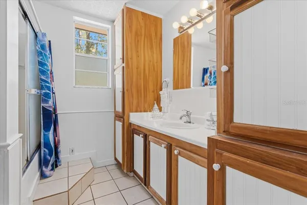 a bathroom with a sink and a mirror