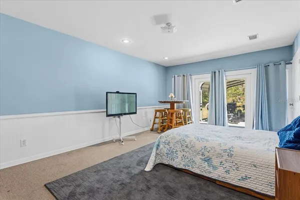 a bedroom with a large bed and a window