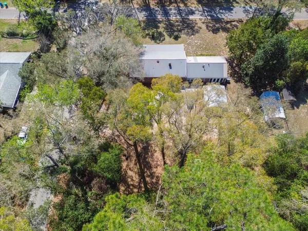 an aerial view of a house with a yard