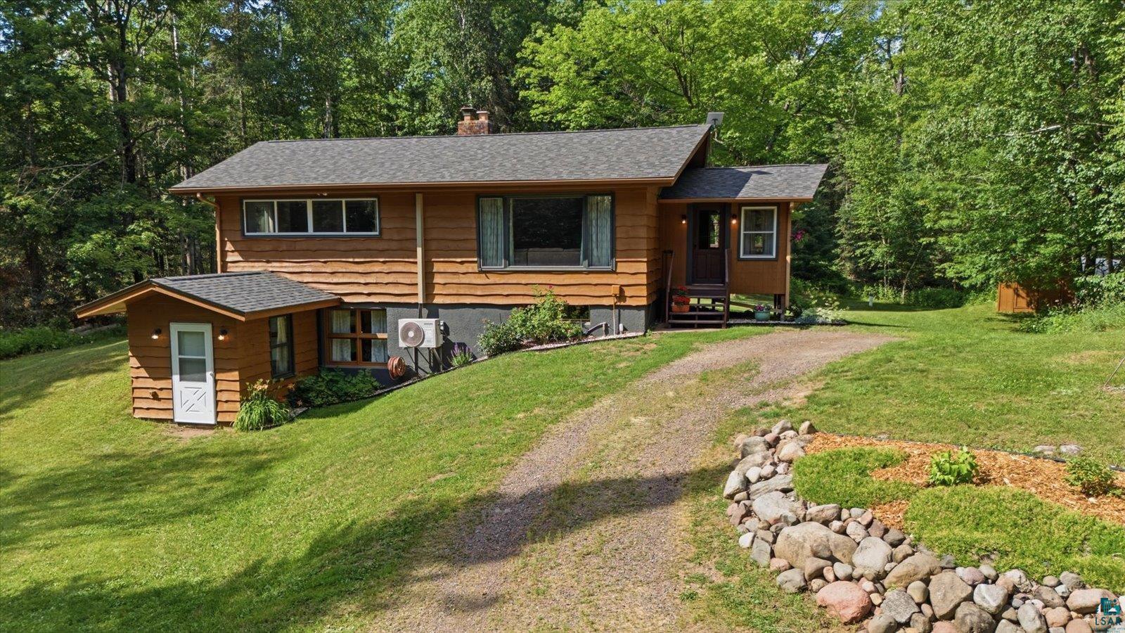 Two-story residence featuring wood siding and a shingle roof