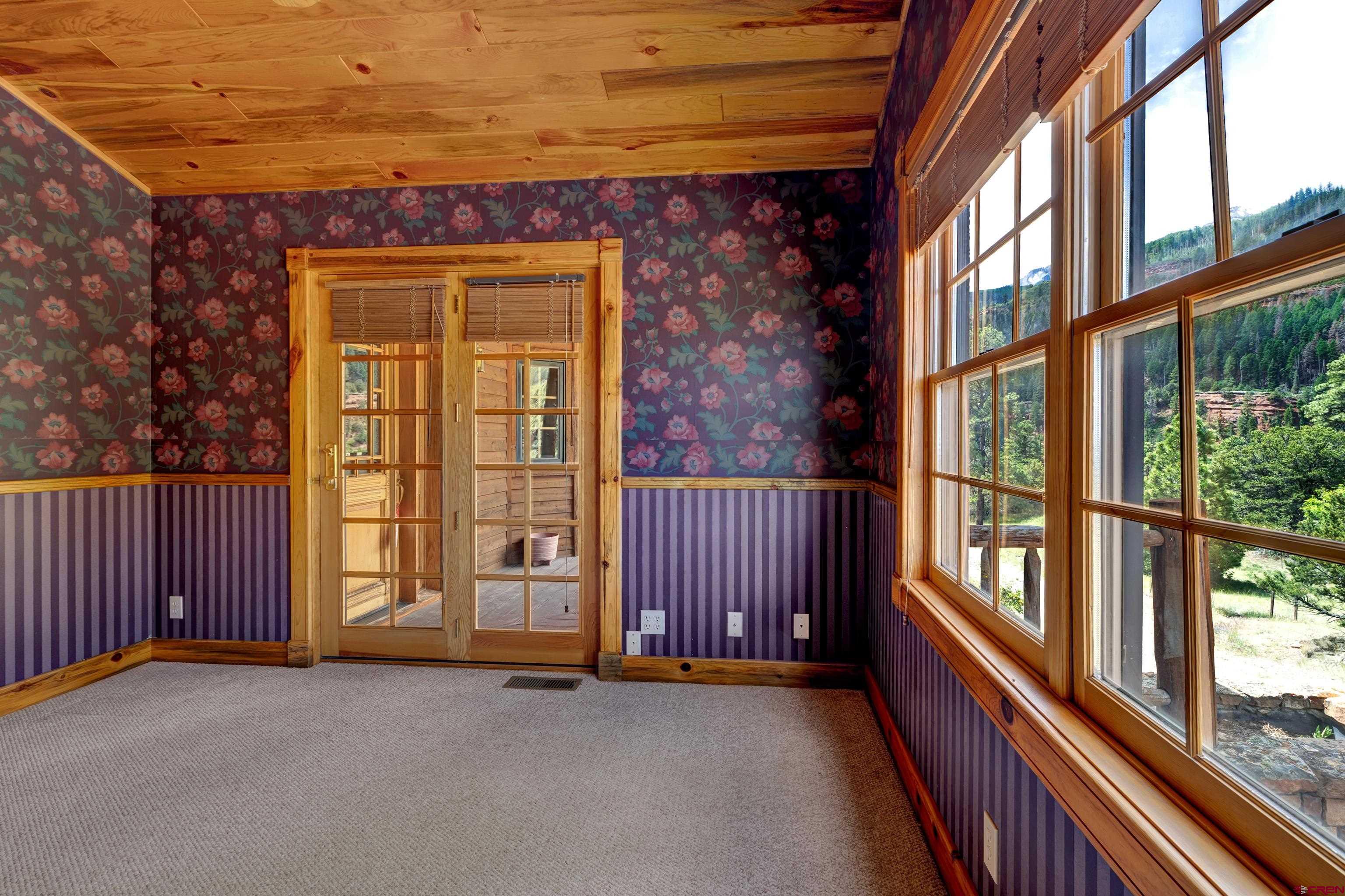 2692 County Road 17 Ridgway, CO 81432 - Photo 23 of 38 a view of a balcony with wooden floor and iron fence