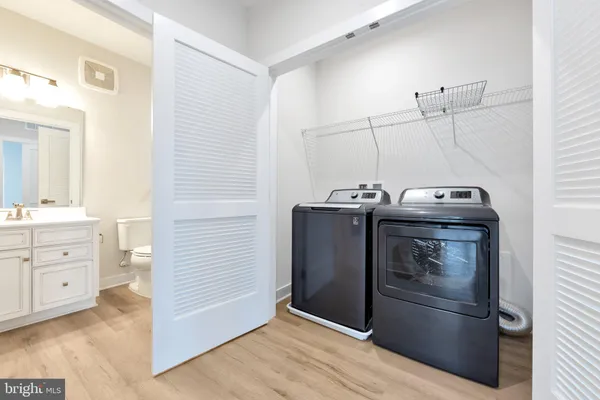 a bathroom with a granite countertop sink mirror and toilet