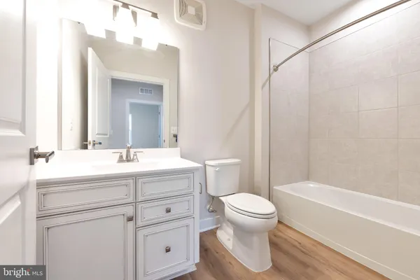 a view of a balcony with wooden floor and fence