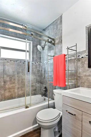 a bathroom with a sink toilet and shower