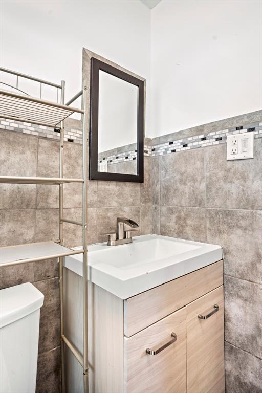 101 Northeast 35th Street, Unit A Pompano Beach, FL 33064 - Photo 17 of 23 a bathroom with a sink toilet and vanity