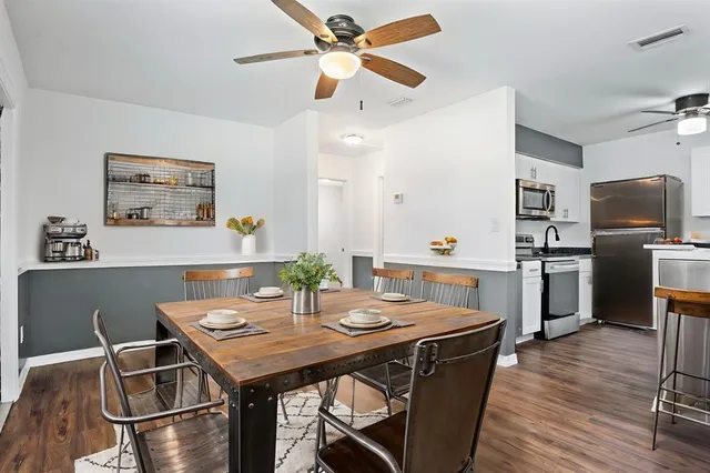 a view of a dining room with furniture and wooden floor