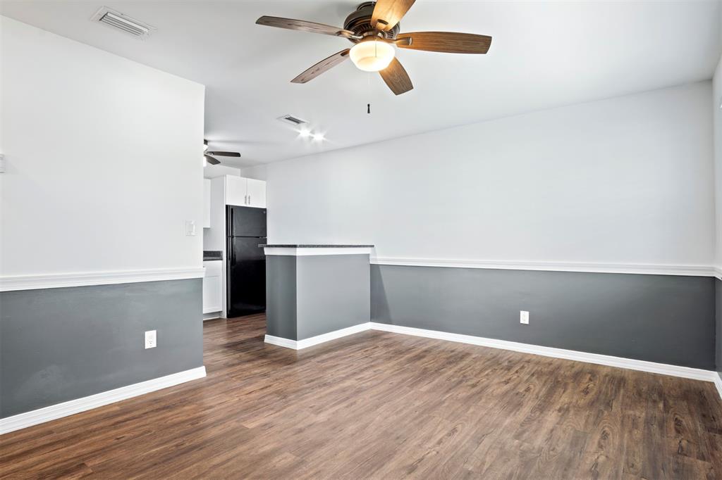 101 Northeast 35th Street, Unit A Pompano Beach, FL 33064 - Photo 8 of 23 wooden floor in an empty room with a kitchen