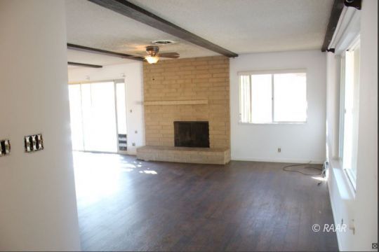 240 South Forest Knoll Street Ridgecrest, CA 93555 - Photo 4 of 23 a view of empty room with wooden floor and fireplace