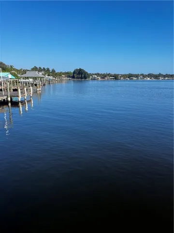 a view of a balcony with floor to ceiling windows and wooden fence
