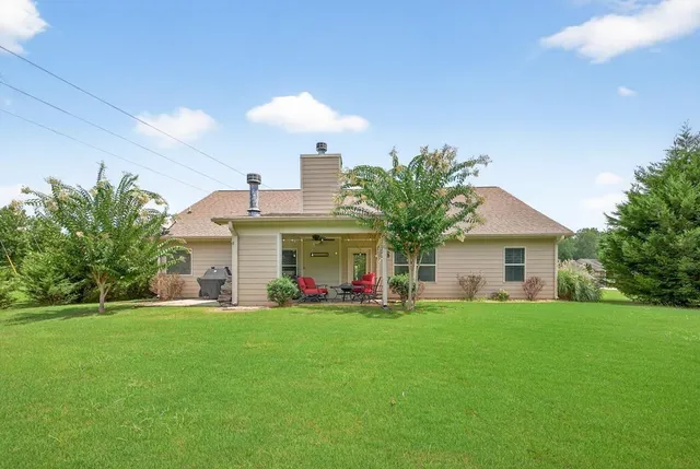 a view of a house with a yard porch and sitting area