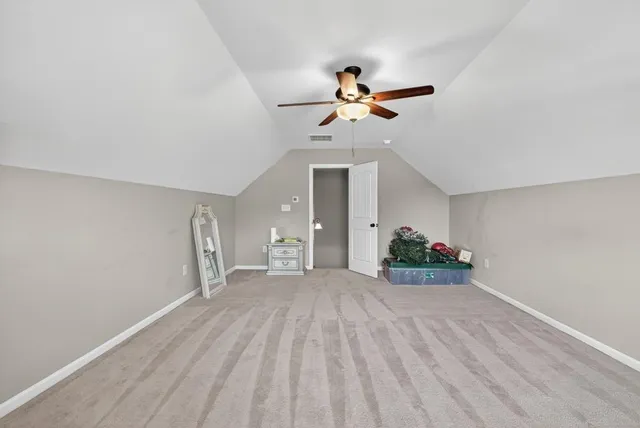 a view of a livingroom with a ceiling fan and window