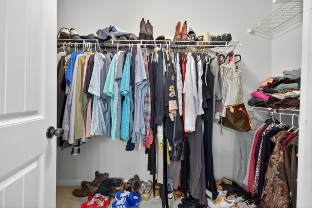 a view of walk in closet with clothes