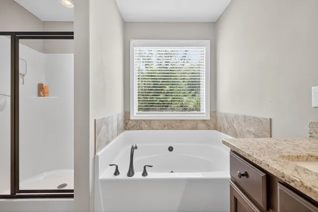 a bathroom with a bathtub and a window