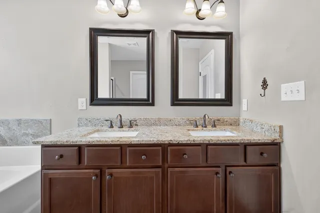 a bathroom with a double vanity sink and mirror