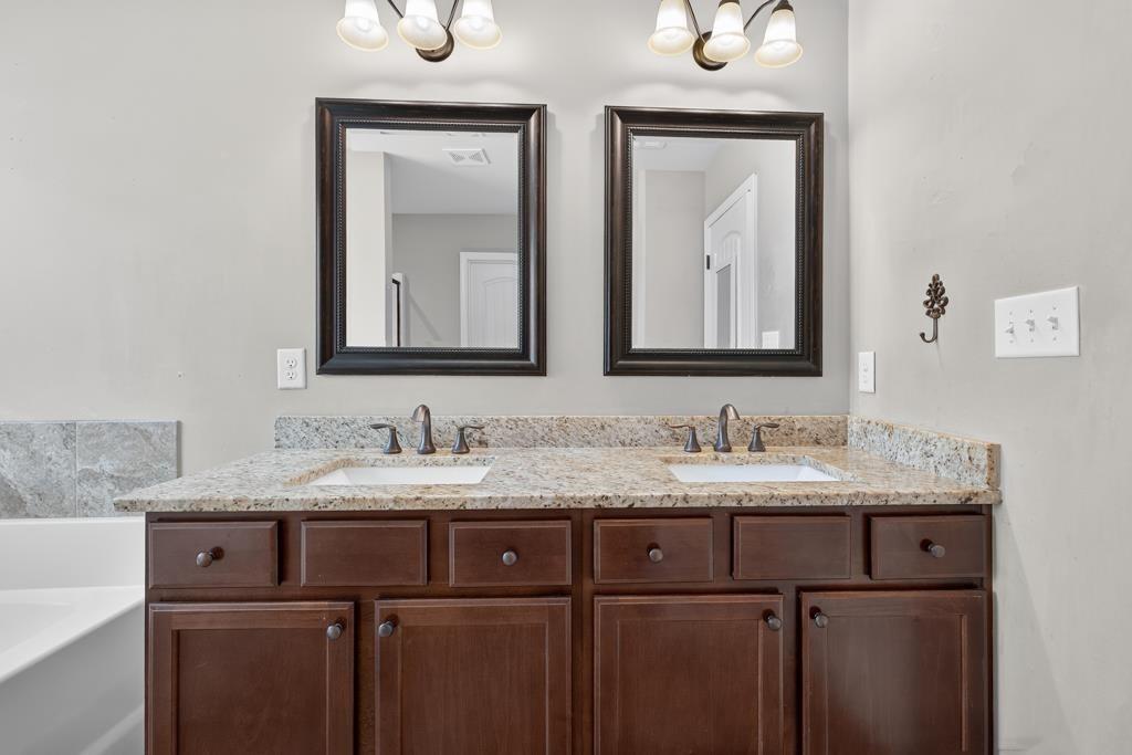 445 Katherine Drive Jefferson, GA 30549 - Photo 21 of 41 a bathroom with a double vanity sink and mirror