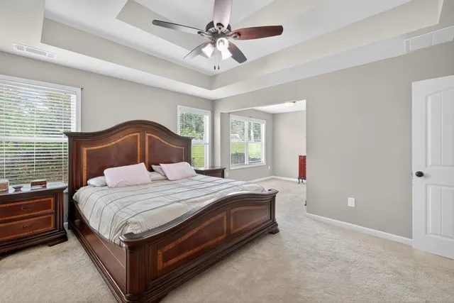 a bedroom with a bed and a ceiling fan