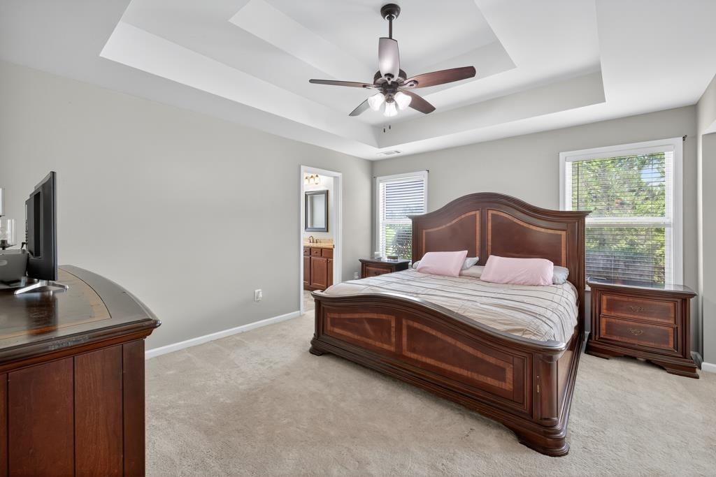 445 Katherine Drive Jefferson, GA 30549 - Photo 27 of 41 a bedroom with a bed and a flat tv screen on the dresser