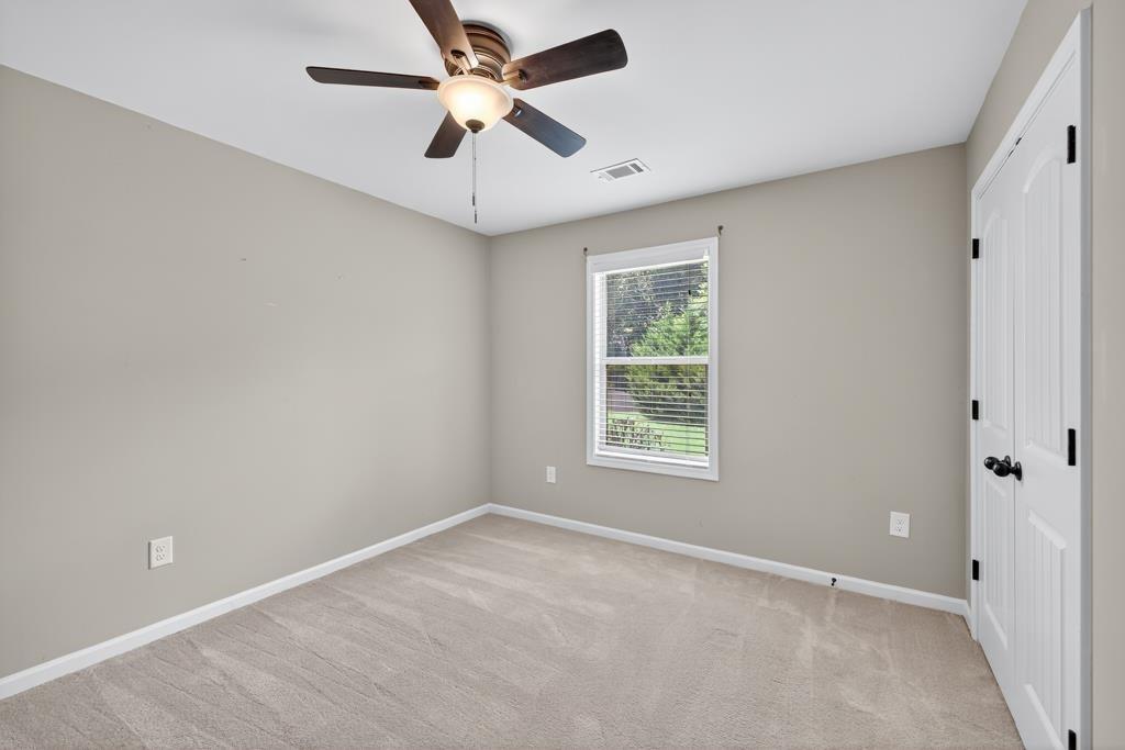445 Katherine Drive Jefferson, GA 30549 - Photo 30 of 41 an empty room with a window and a fan