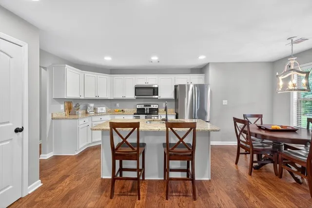 a view of a dining room with furniture and wooden floor