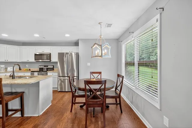 a view of a dining room with furniture window and wooden floor