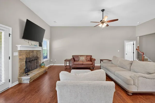 a living room with furniture a fireplace and a flat screen tv