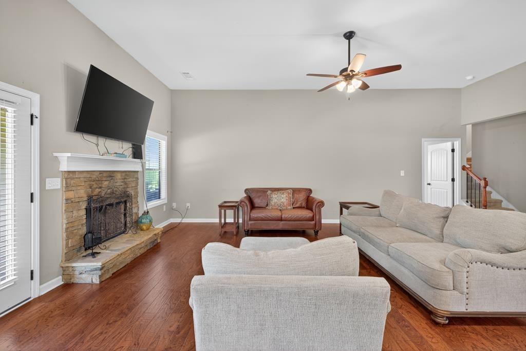 445 Katherine Drive Jefferson, GA 30549 - Photo 41 of 41 a living room with furniture a fireplace and a flat screen tv