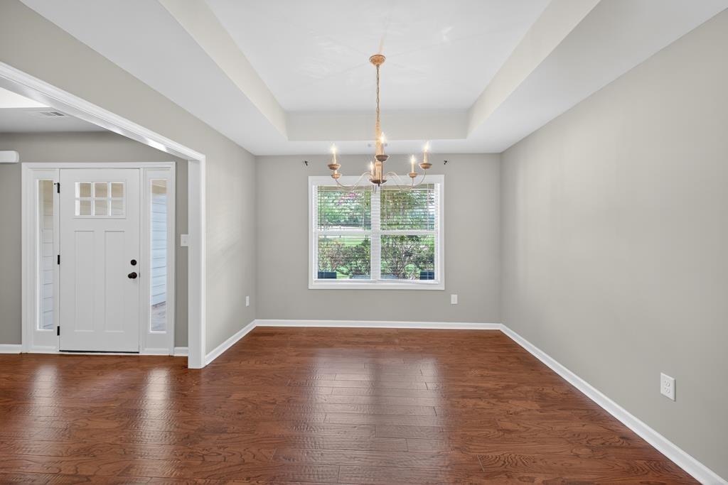 445 Katherine Drive Jefferson, GA 30549 - Photo 9 of 41 an empty room with wooden floor and windows
