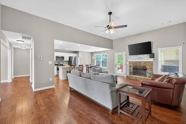 a living room with furniture a fireplace and a flat screen tv