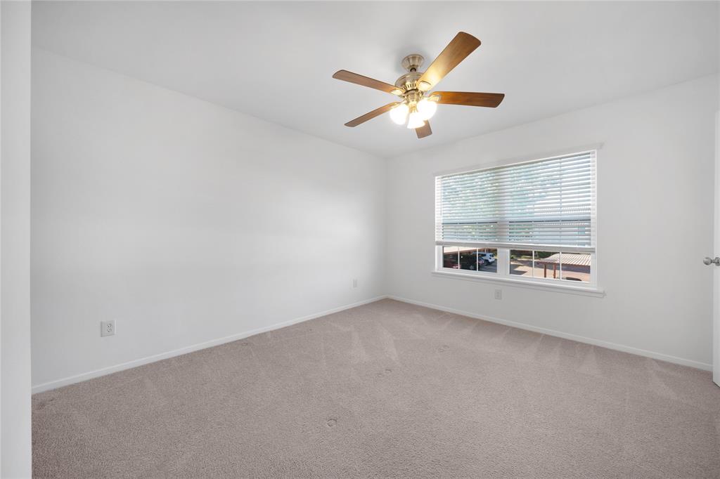 5626 Preston Oaks Road, Unit 16D Dallas, TX 75254 - Photo 17 of 29 an empty room with windows and fan