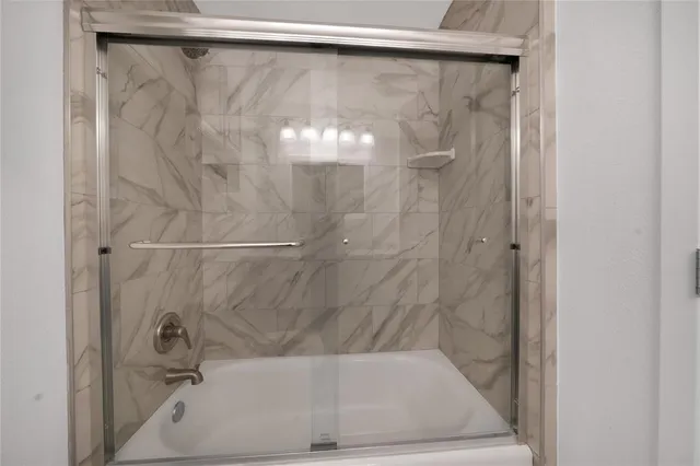 a bathroom with a shower and a sink