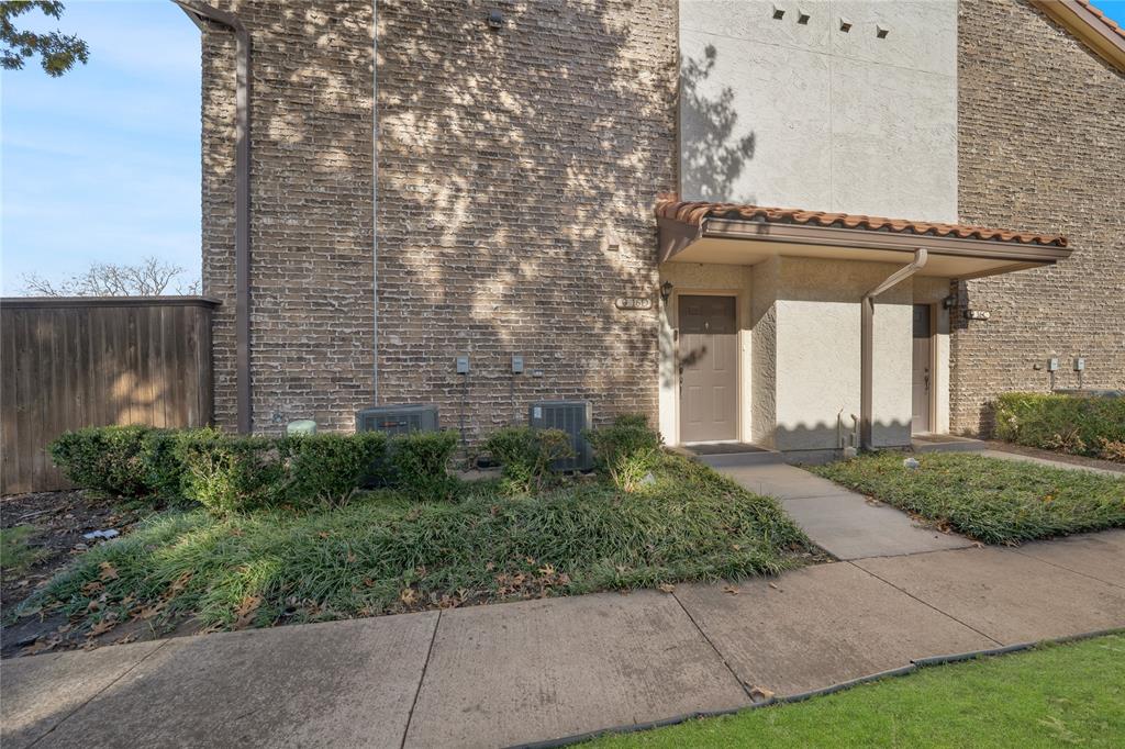 5626 Preston Oaks Road, Unit 16D Dallas, TX 75254 - Photo 24 of 29 a view of a building with a yard