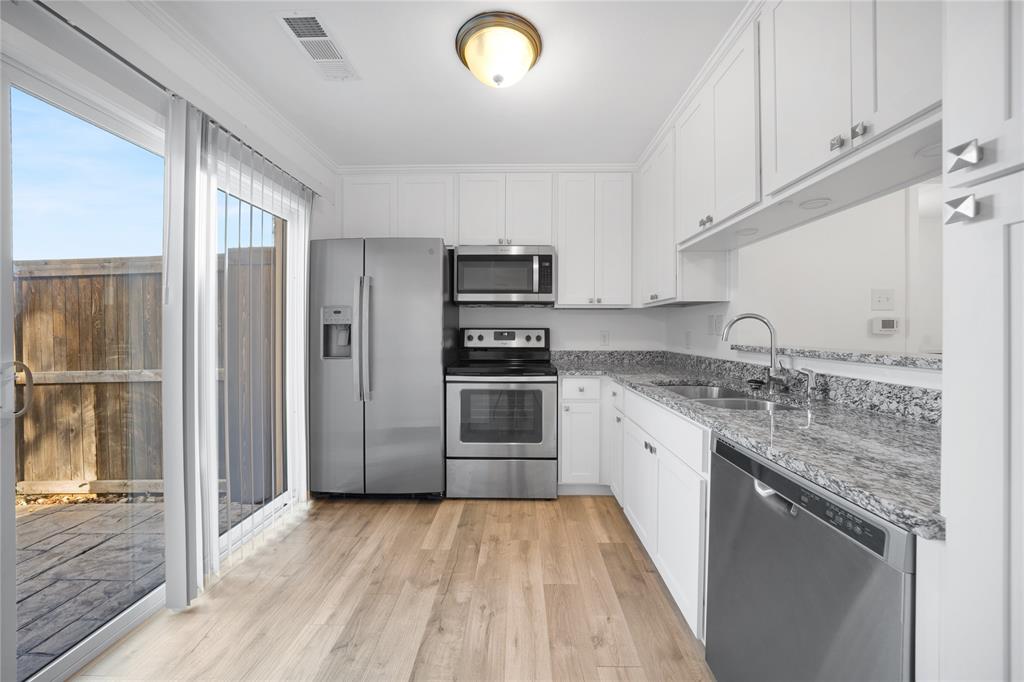 5626 Preston Oaks Road, Unit 16D Dallas, TX 75254 - Photo 7 of 29 a kitchen with granite countertop a refrigerator stove and sink