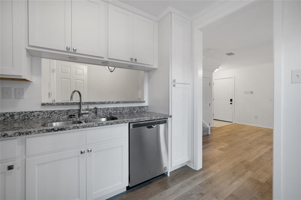5626 Preston Oaks Road, Unit 16D Dallas, TX 75254 - Photo 9 of 29 a kitchen with a sink and cabinets