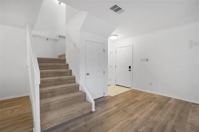 a view of an entryway with wooden floor