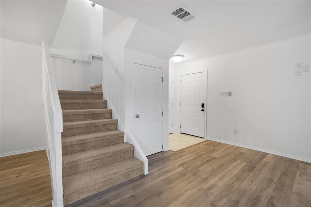 5626 Preston Oaks Road, Unit 16D Dallas, TX 75254 - Photo 10 of 29 a view of an entryway with wooden floor