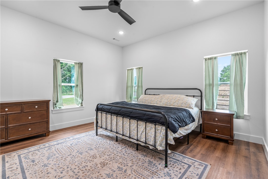 16556 East Hewitt Springs Road Springdale, AR 72764 - Photo 45 of 60 Spacious room featuring vaulted ceilings, wood-finish flooring, recessed lighting, and a contemporary ceiling fan