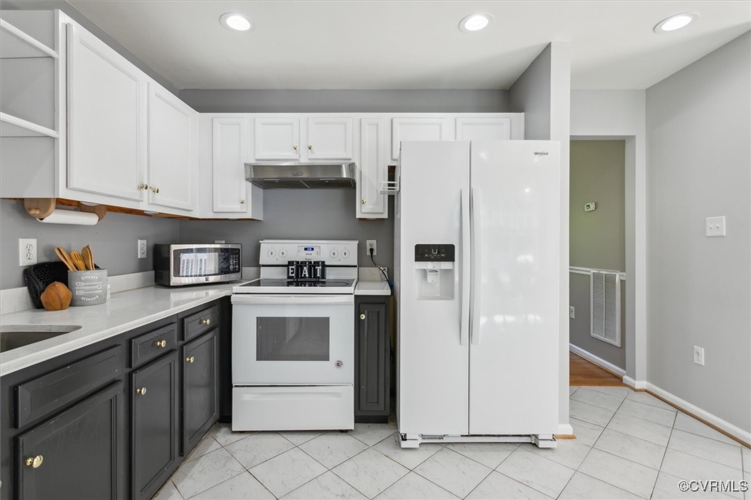 203 Oaktree Road, Unit A Williamsburg, VA 23188 - Photo 17 of 46 Kitchen with white cabinetry, white appliances, an